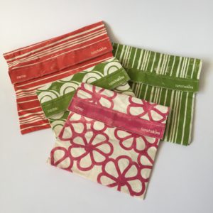 Four Lunchskins: two in green stripes, one in red stripes and one in fuchsia flower pattern