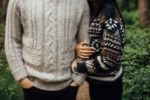 Couple arm in arm wearing warm sweaters