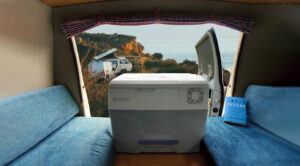 View from within a camping van over the GoSun Chill portable cooler and the coast line